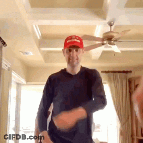 Man In Red Supreme Hat Dancing In Living Room GIF