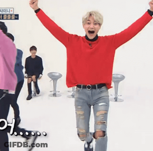 Man In Red Sweater And Ripped Jeans Jumping GIF