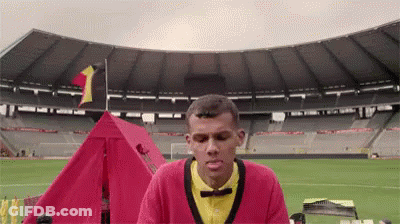 Man In Red Sweater At Stadium With Red Tent GIF