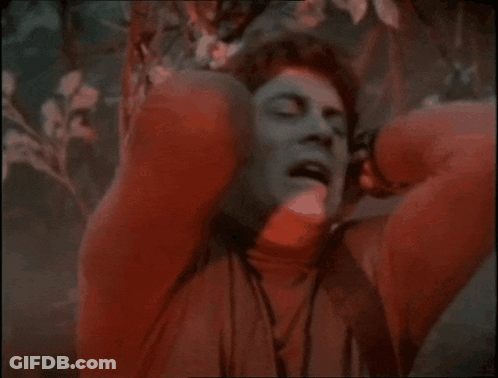 Man In Red Sweater Covering Ears GIF