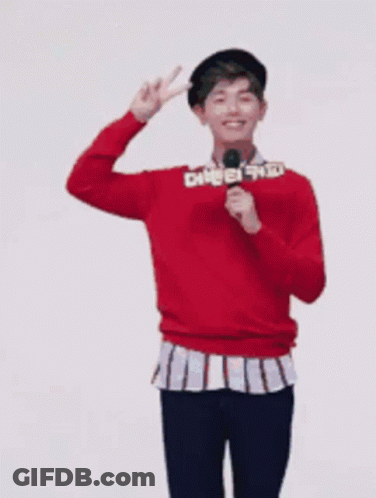 Man In Red Sweater Holding Microphone And Peace Sign GIF