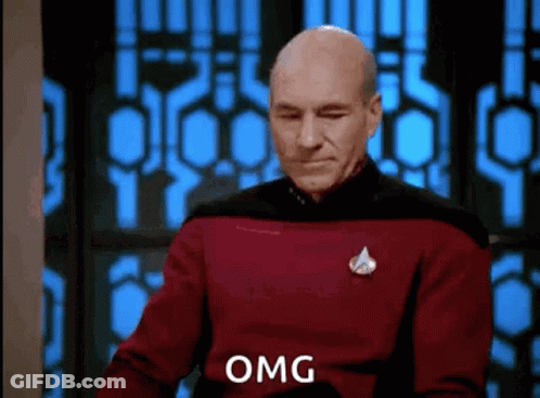 Man In Red Sweater Making Funny Face By Window GIF