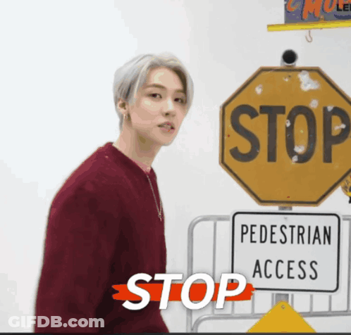 Man In Red Sweater Near Stop Sign GIF