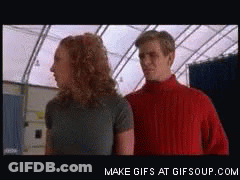 Man In Red Sweater Next To Woman GIF