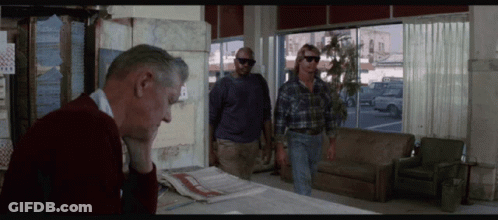 Man In Red Sweater Sitting At Table With Two Men GIF