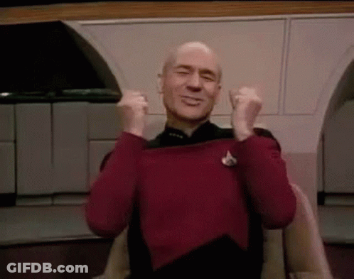 Man In Red Sweater Sitting With Arms Up Saying Thank You GIF