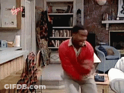 Man In Red Sweater Standing In Living Room GIF