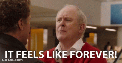 Man In Red Sweater Talking To Man In Black Jacket GIF