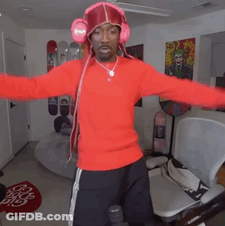 Man In Red Sweater With Headphones Standing In Room GIF