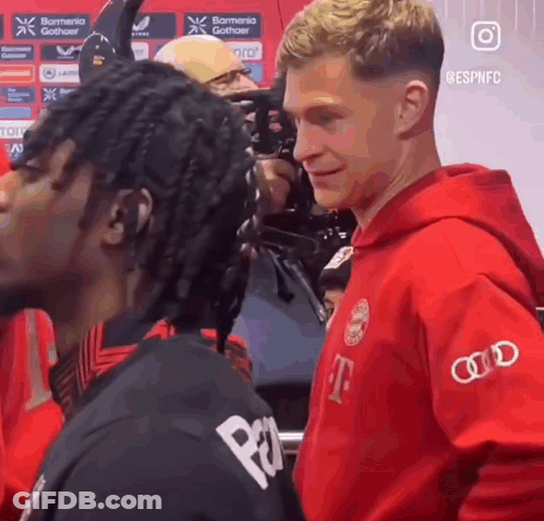 Man In Red T-Mobile Hoodie Next To Man In Black Shirt GIF