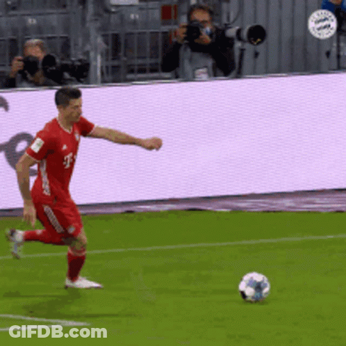 Man In Red T-Mobile Jersey Kicks Soccer Ball GIF