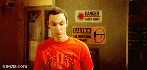 Man In Red T-Shirt In Front Of Danger Laser Sign GIF