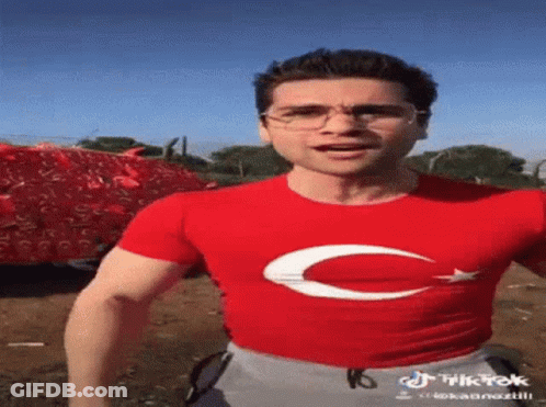 Man In Red T-Shirt With White Crescent Moon GIF