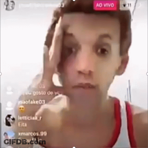 Man In Red Tank Top Holding Hand To Forehead GIF