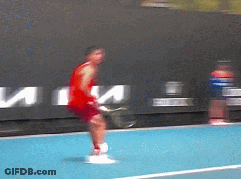 Man In Red Tank Top Holding Tennis Racquet GIF