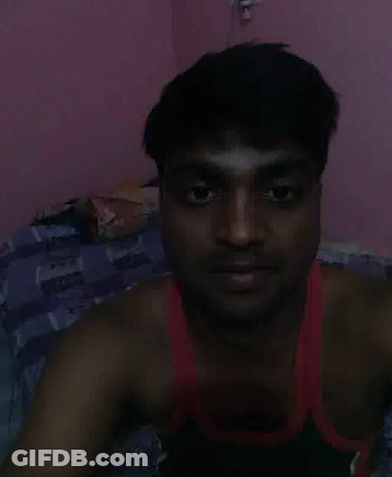 Man In Red Tank Top Lying On Bed GIF