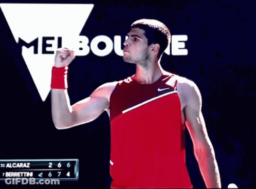 Man In Red Tank Top Standing At Melbourne Sign GIF