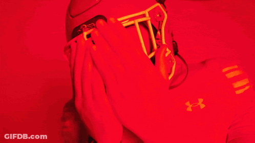 Man In Red Under Armour Shirt Covering Face GIF