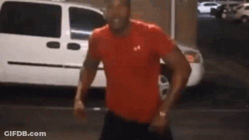 Man In Red Under Armour Shirt Standing In Front Of White Van GIF