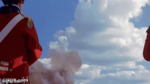 Man In Red Uniform Against Cloudy Blue Sky GIF