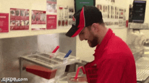 Man In Red Uniform Cooking GIF