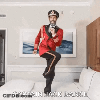 Man In Red Uniform Dancing On Bed GIF