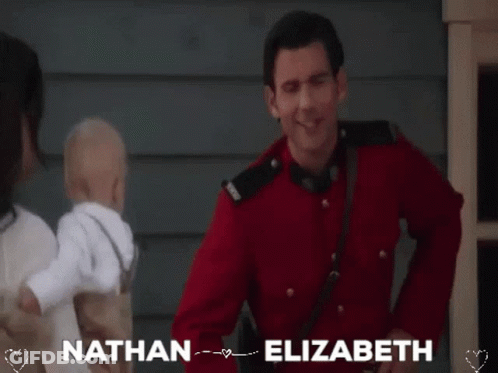 Man In Red Uniform Holding Baby GIF