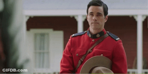 Man In Red Uniform Holding Hat GIF