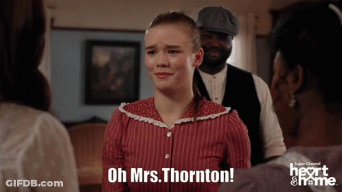 Man In Red Uniform In Front Of Heart & Name Building GIF
