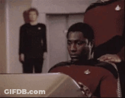 Man In Red Uniform Sitting At Computer GIF