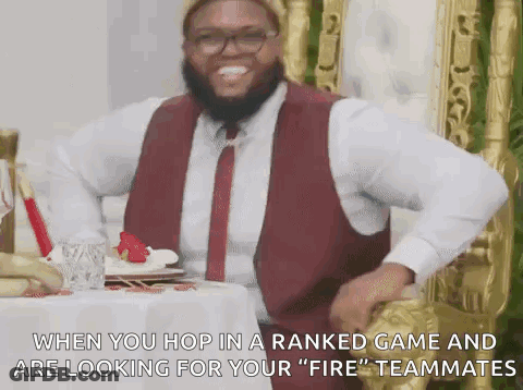 Man In Red Vest And Tie At Table GIF