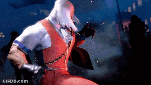 Man In Red Vest Holding Chain Around Neck GIF