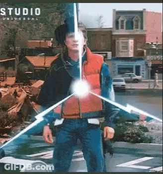 Man In Red Vest In Front Of Studio Universal Building GIF