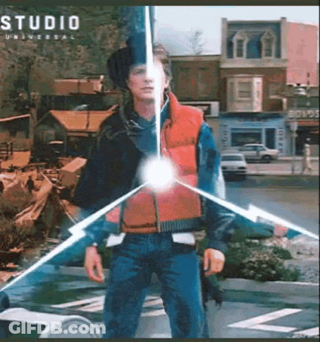 Man In Red Vest In Front Of Studio Universal Building GIF