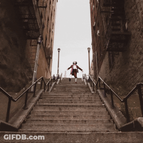 Man In Red White And Blue Outfit Walking Up Stairs GIF