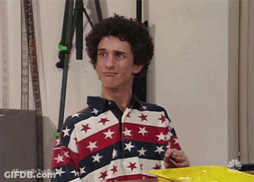 Man In Red White Blue Star Shirt Holding Yellow Tray GIF