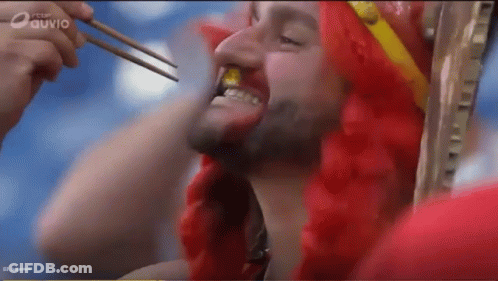 Man In Red Wig Eating With Chopsticks On Ouvio Screen GIF