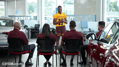 Man In Redskins Jersey Giving Presentation GIF