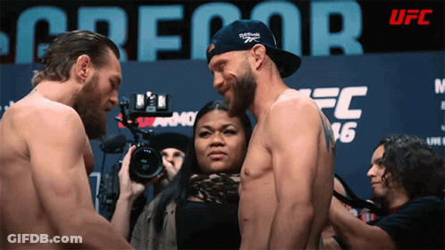 Man In Reebok Hat Standing Next To Another Man GIF