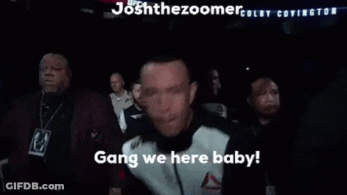 Man In Reebok Jacket Standing In Crowd GIF