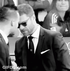 Man In Reebok Jacket Walking Through Crowd GIF