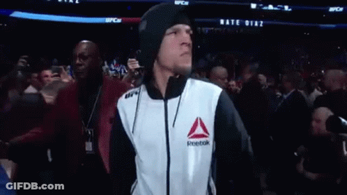 Man In Reebok Jacket Walking Through Crowd GIF