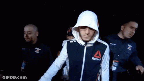 Man In Reebok Jacket Walks Through Crowd GIF