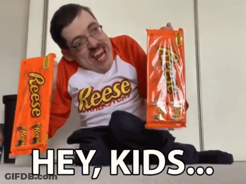 Man In Reese's Shirt Holding Reese's Peanut Butter Cups GIF