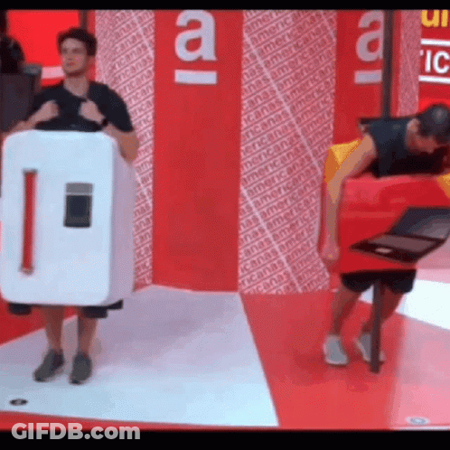 Man In Refrigerator Costume Standing Next To Another Man GIF