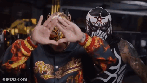 Man In Rey Fenix Hoodie Next To Masked Man GIF