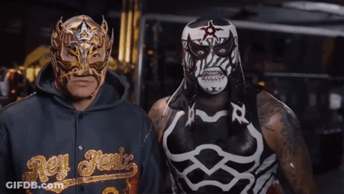 Man In Rey Fenix Hoodie Next To Masked Man GIF