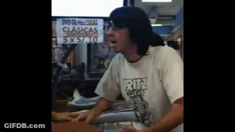 Man In Ritz Shirt In Front Of 3 X 5 / 10 Sign GIF