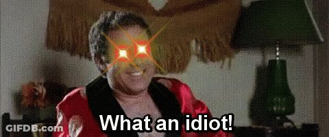 Man In Robe Sitting In Front Of Lamp Says What An Idiot GIF