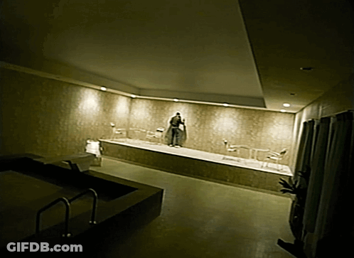 Man In Robe Standing In Bathtub GIF
